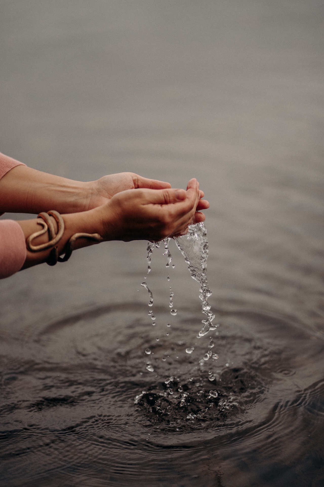 Hands releasing water